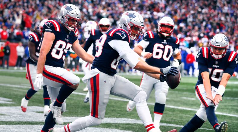 New England Patriots tight end Mike Gesicki, center, celebrates with teammates after his touchdown against the Buffalo Bills during the second half of an NFL football game, Sunday, Oct. 22, 2023, in Foxborough, Mass. (AP Photo/Michael Dwyer)