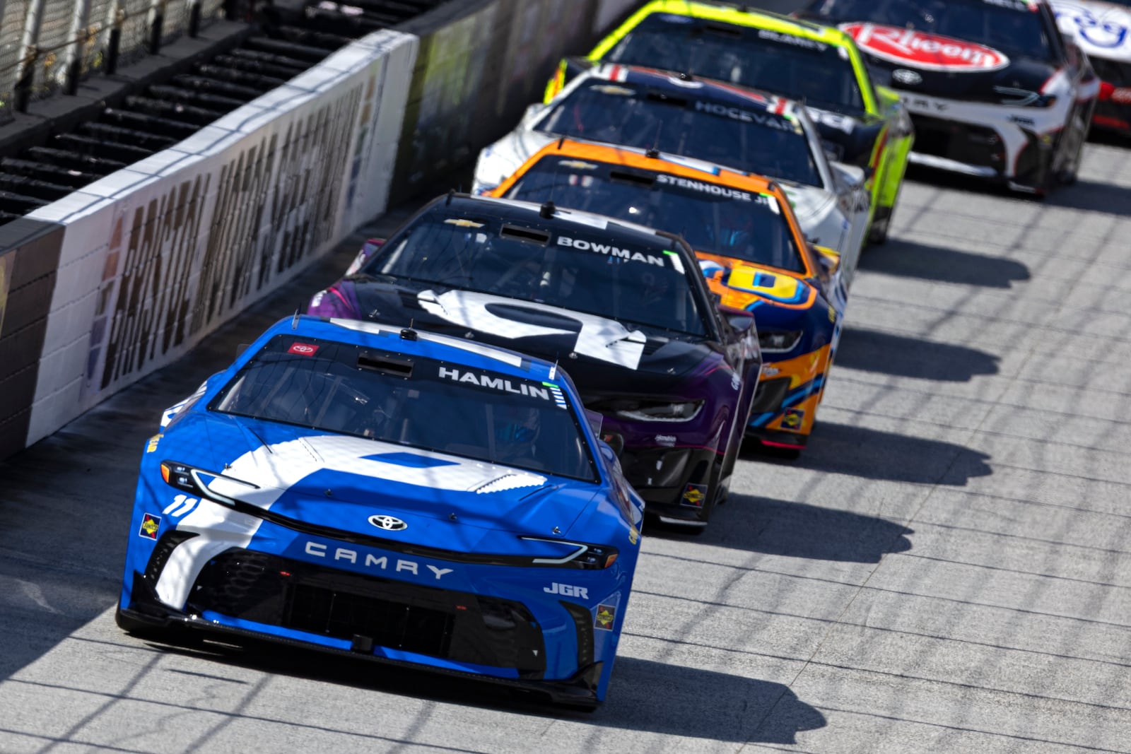 Denny Hamlin (11) leads Alex Bowman (48), Ricky Stenhouse Jr. (47), and others during a NASCAR Cup Series auto race, Sunday, April 13, 2025, in Bristol, Tenn. (AP Photo/Wade Payne)