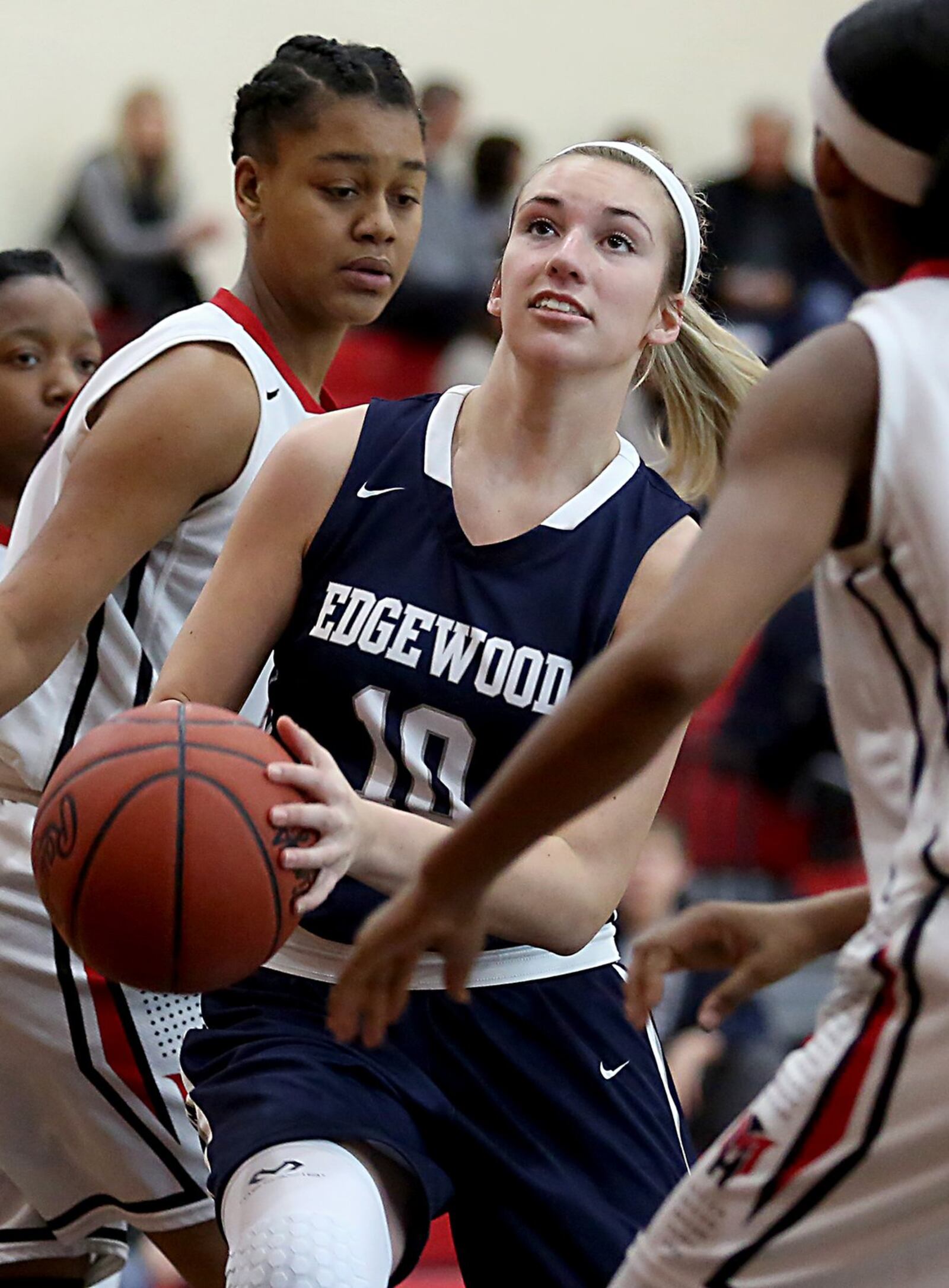 Edgewood guard Lauren Gerber splits Mt. Healthy defenders Kimara Richard and Gabrielle Barnett to score during their game at Mt. Healthy on Saturday afternoon. CONTRIBUTED PHOTO BY E.L. HUBBARD