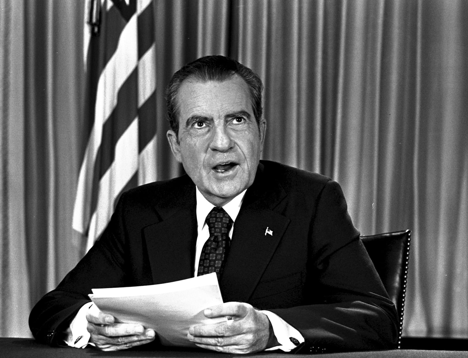 FILE - President Richard Nixon sits in his White House office, Aug. 16, 1973, as he poses for pictures after delivering a nationwide television address dealing with Watergate. (AP Photo, File)