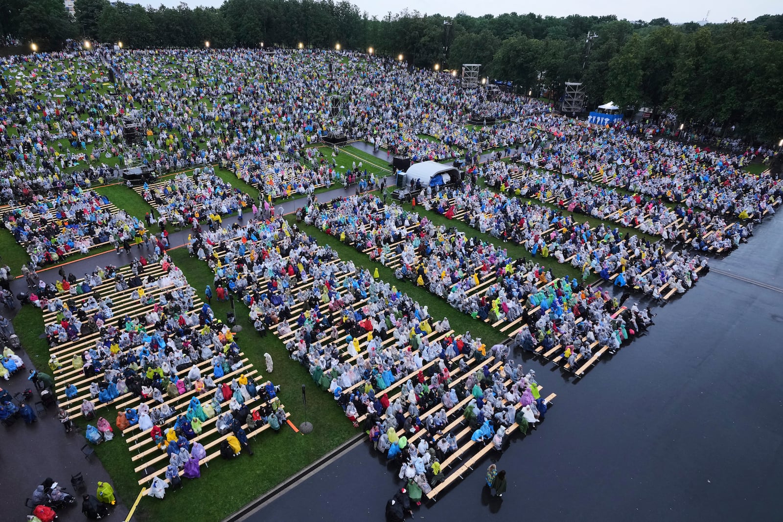 People enjoy the Estonian Song Festival, part of the "Iseoma" Song and Dance Celebration, at the Song Festival Grounds in Tallinn, Estonia, Saturday, July 5, 2025. (AP Photo/Sergei Grits)