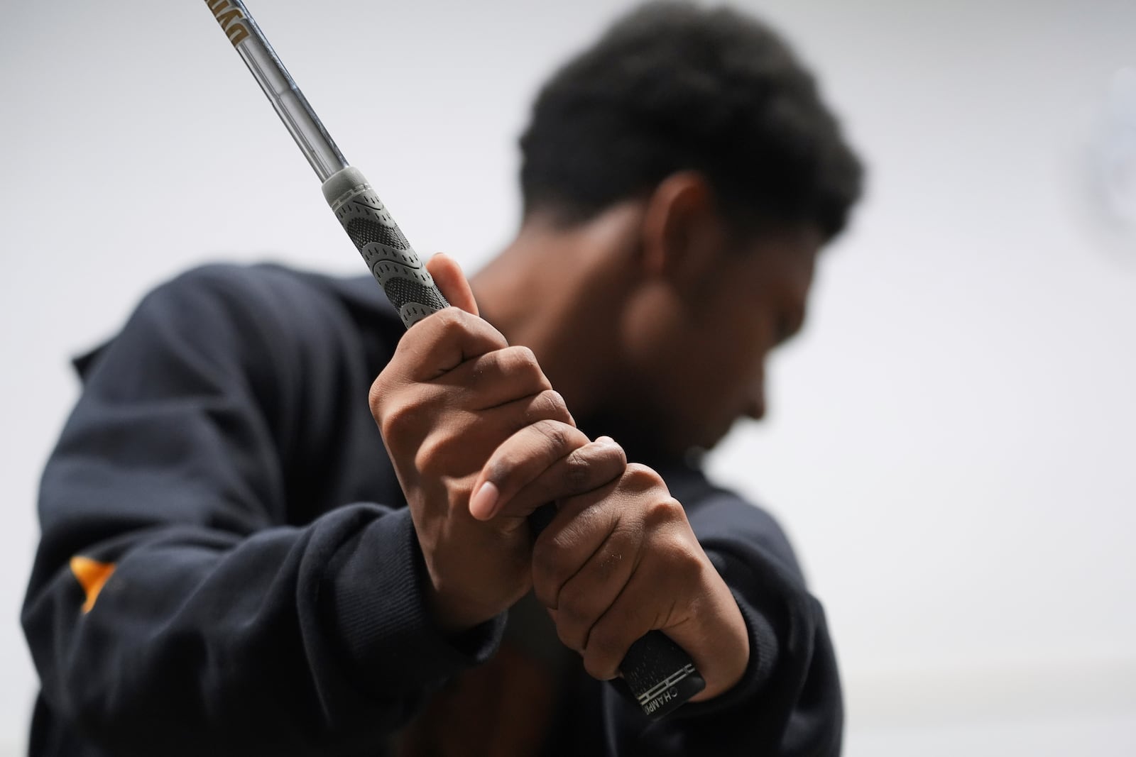 Shaun Horne, 16, a junior at Renaissance High School practices his golf swing in Detroit, Thursday, Feb. 27, 2025. (AP Photo/Paul Sancya)