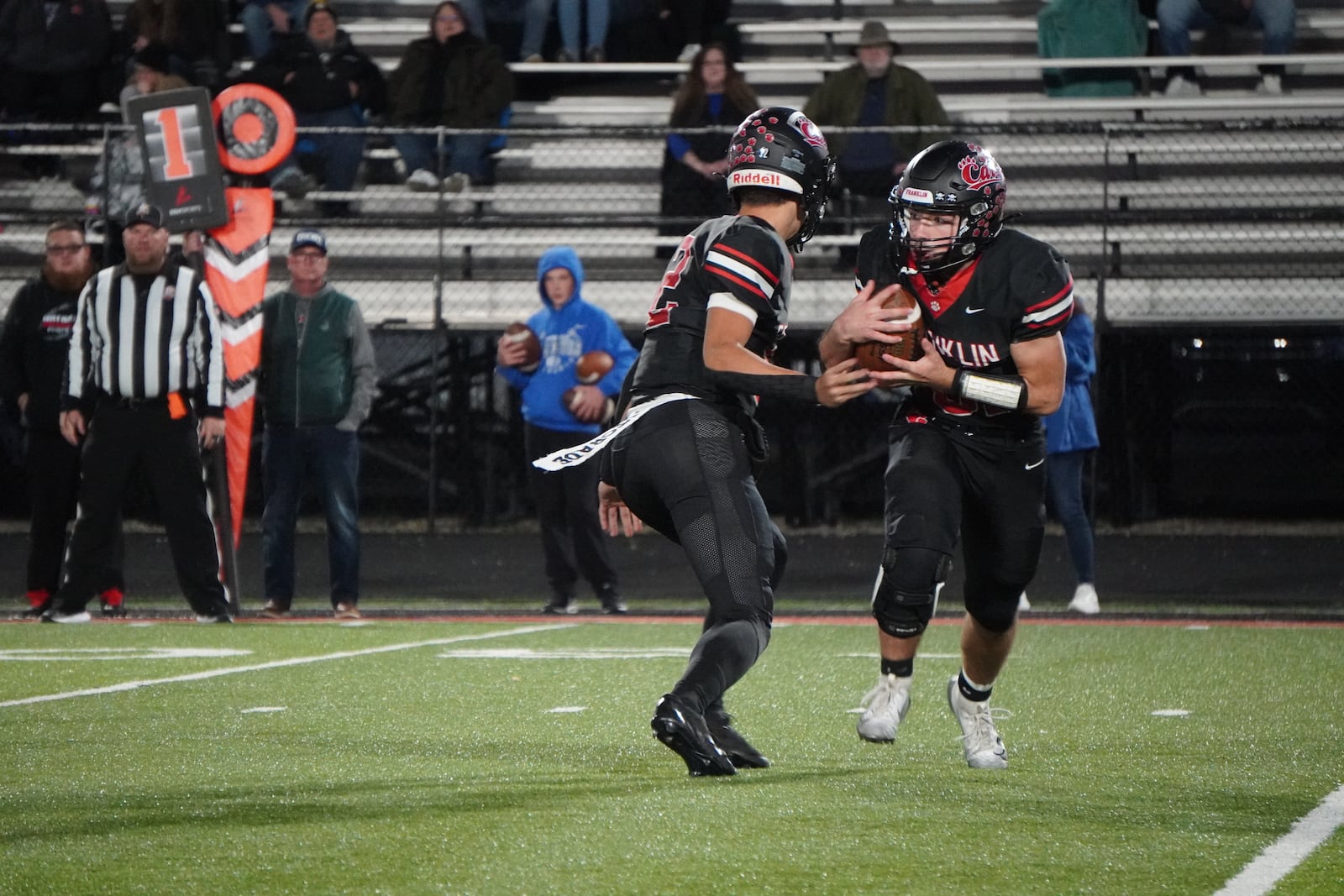 Franklin’s Connor Monk takes a handoff against Brookville on Friday night at Atrium Stadium. CHRIS VOGT / CONTRIBUTED