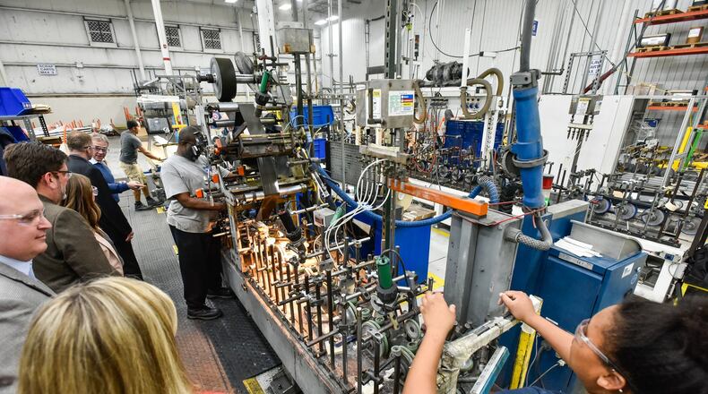 Employees work in the production area at Deceuninck North America Wednesday, March 28 in Monroe. Deceuninck has upgraded multiple extrusion lines and increased extrusion capacity. In addition, a nearly $30 million expansion means 250,000 square feet of warehouse space. NICK GRAHAM/STAFF