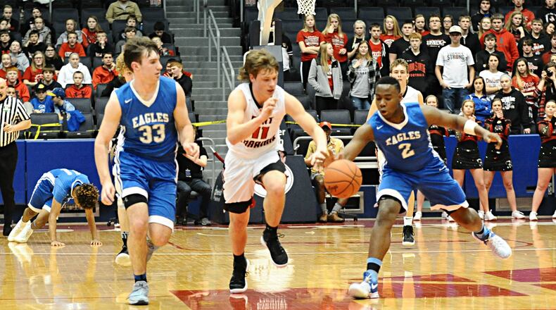 Middletown Christian’s Jarod Hamlin (33) and Dre Shores (2) battle Fort Loramie’s Nick Brandewie (11) for the ball during Friday night’s Division IV district final at the University of Dayton Arena. CONTRIBUTED PHOTO