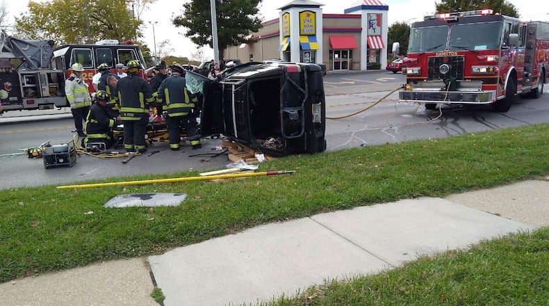 Firefighters responded to rescue a man from a vehicle on its side after a crash at NW Washington Boulevard near Brookwood Avenue Monday, Oct. 31, in Hamilton. CONTRIBUTED/RACHEL McCOY