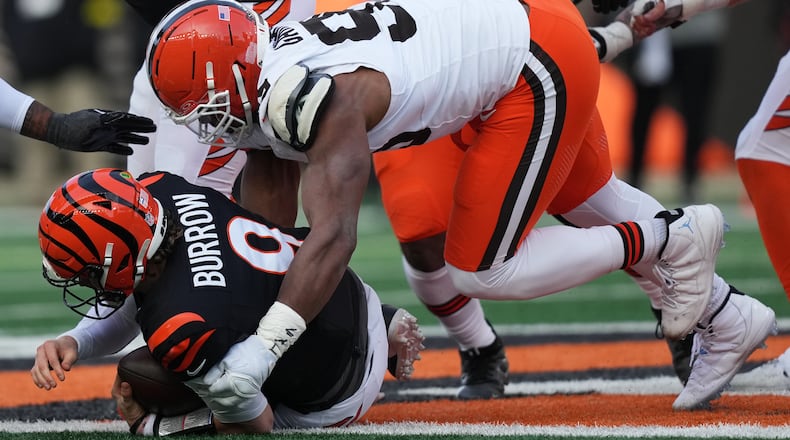 Cleveland Browns defensive end Myles Garrett, top, sacks Cincinnati Bengals quarterback Joe Burrow (9) to set an NFL record for sacks in the regular season during the second half of an NFL football game, Sunday, Jan. 4, 2026, in Cincinnati. (AP Photo/Joshua A. Bickel)