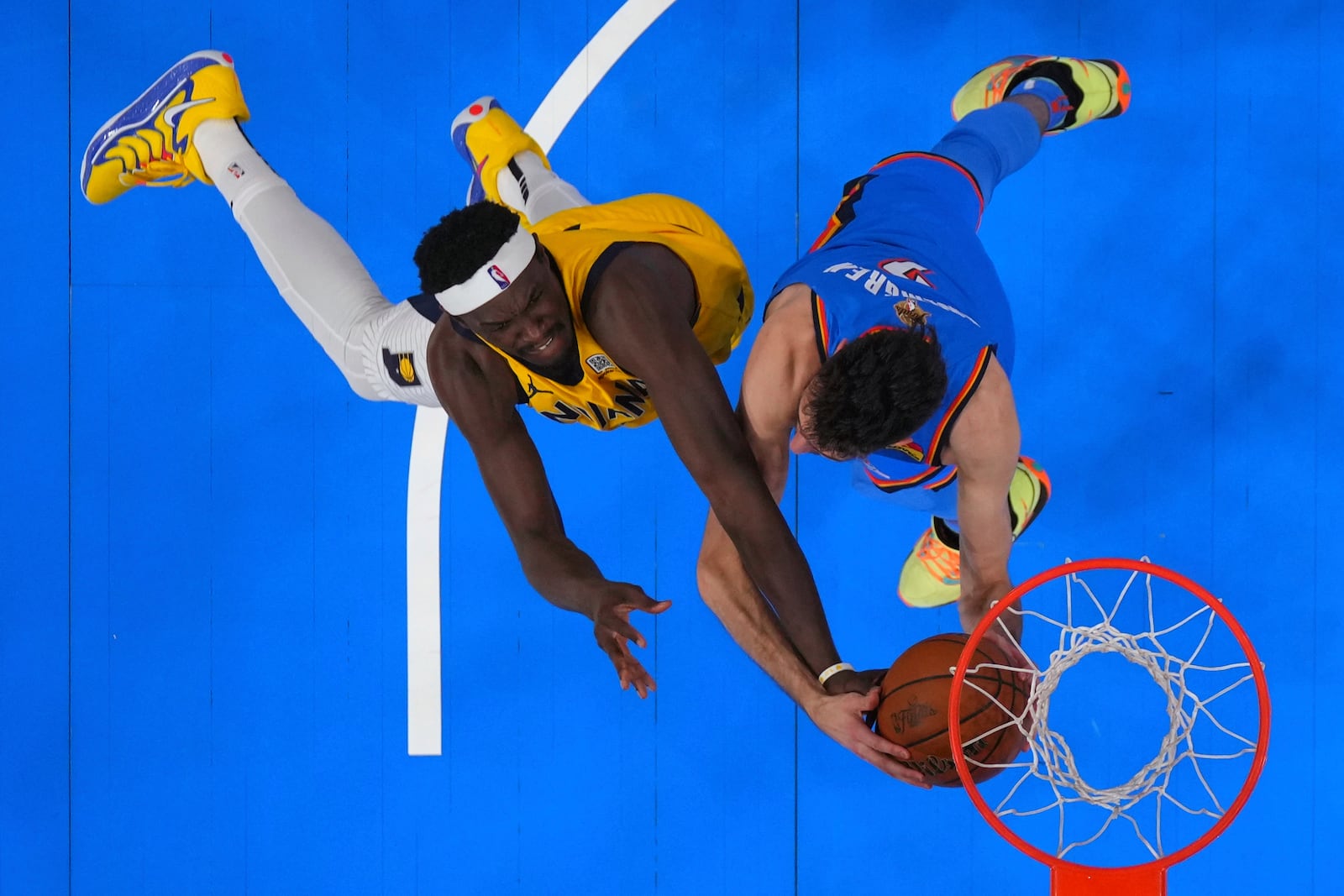 Indiana Pacers forward Pascal Siakam (43) reaches for the ball against Oklahoma City Thunder forward Chet Holmgren (7) during the first half of Game 2 of the NBA Finals basketball series Sunday, June 8, 2025, in Oklahoma City. (Kyle Terada/Pool Photo via AP)
