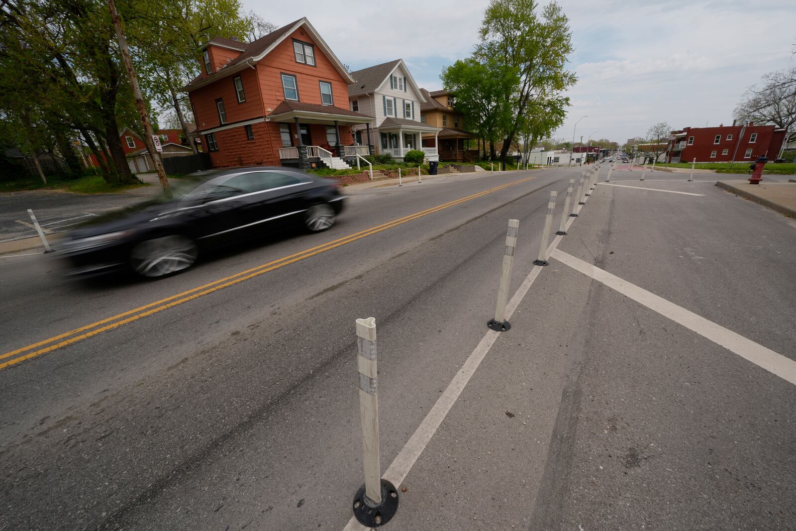A motorist drives on 31st Street in Kansas City, Mo., where the city implemented a "road diet" reducing the street from four lanes to two in an effort to reduce speeding and accidents, Thursday, April 17, 2025. (AP Photo/Charlie Riedel)