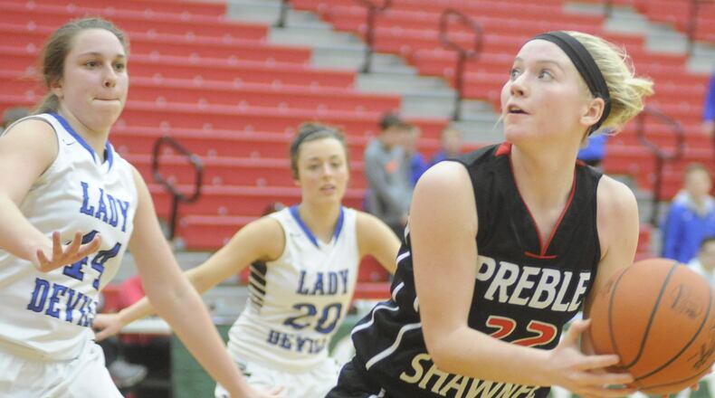 Adrianna Moore of Preble Shawnee (with ball) draws Brookville defenders Allie Conry (left) and Lauren Mellon during a Division III sectional game at Tippecanoe on Feb. 19, 2015. MARC PENDLETON/STAFF