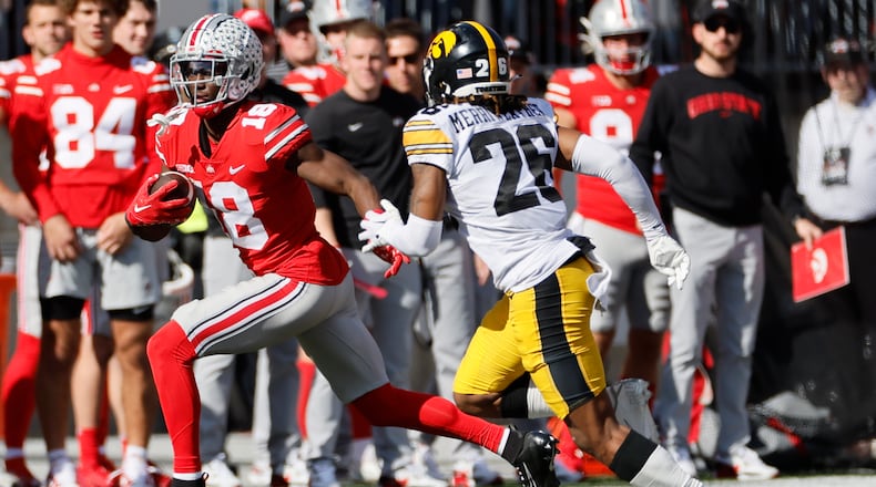 Ohio State receiver Marvin Harrison, left, cuts up field against Iowa defensive back Kaevon Merriweather during the second half of an NCAA college football game Saturday, Oct. 22, 2022, in Columbus, Ohio. (AP Photo/Jay LaPrete)
