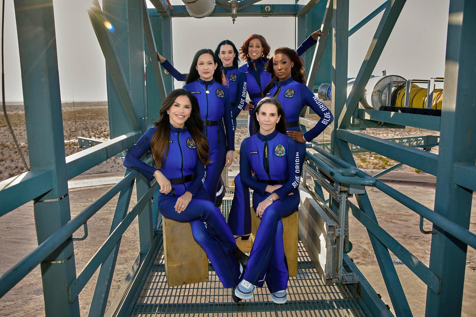 This image provided by Blue Origin shows, first row, seated, from left: Lauren Sanchez and Kerianne Flynn and standing in back from left: Amanda Nguyen, Katy Perry, Gayle King and Aisha Bowe in West Texas. (Blue Origin via AP)