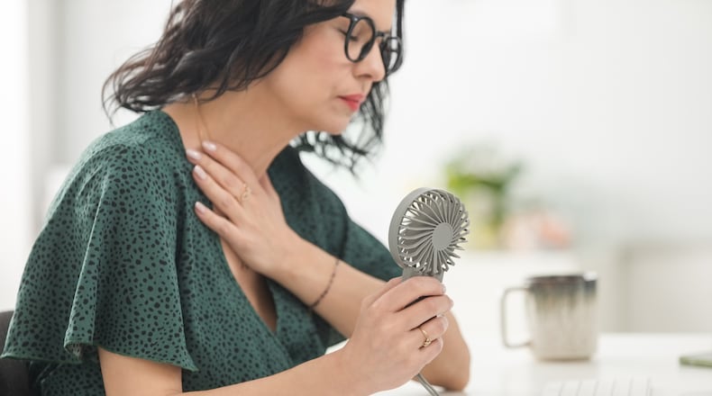 Common menopause experiences include hot flashes, night sweats, mood swings, sleep disturbances and metabolic changes, that involve weight gain and blood sugar control issues. ISTOCK PHOTO