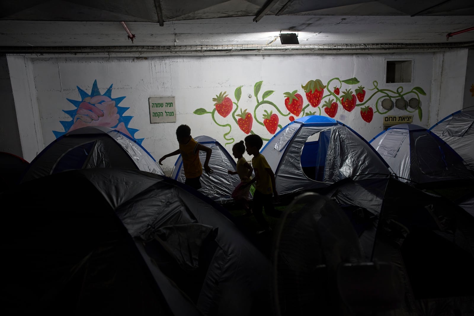 Children play in a public bomb shelter in Tel Aviv, Israel, on Saturday, June 21, 2025, amid concerns over potential Iranian missile attacks. (AP Photo/Oded Balilty)