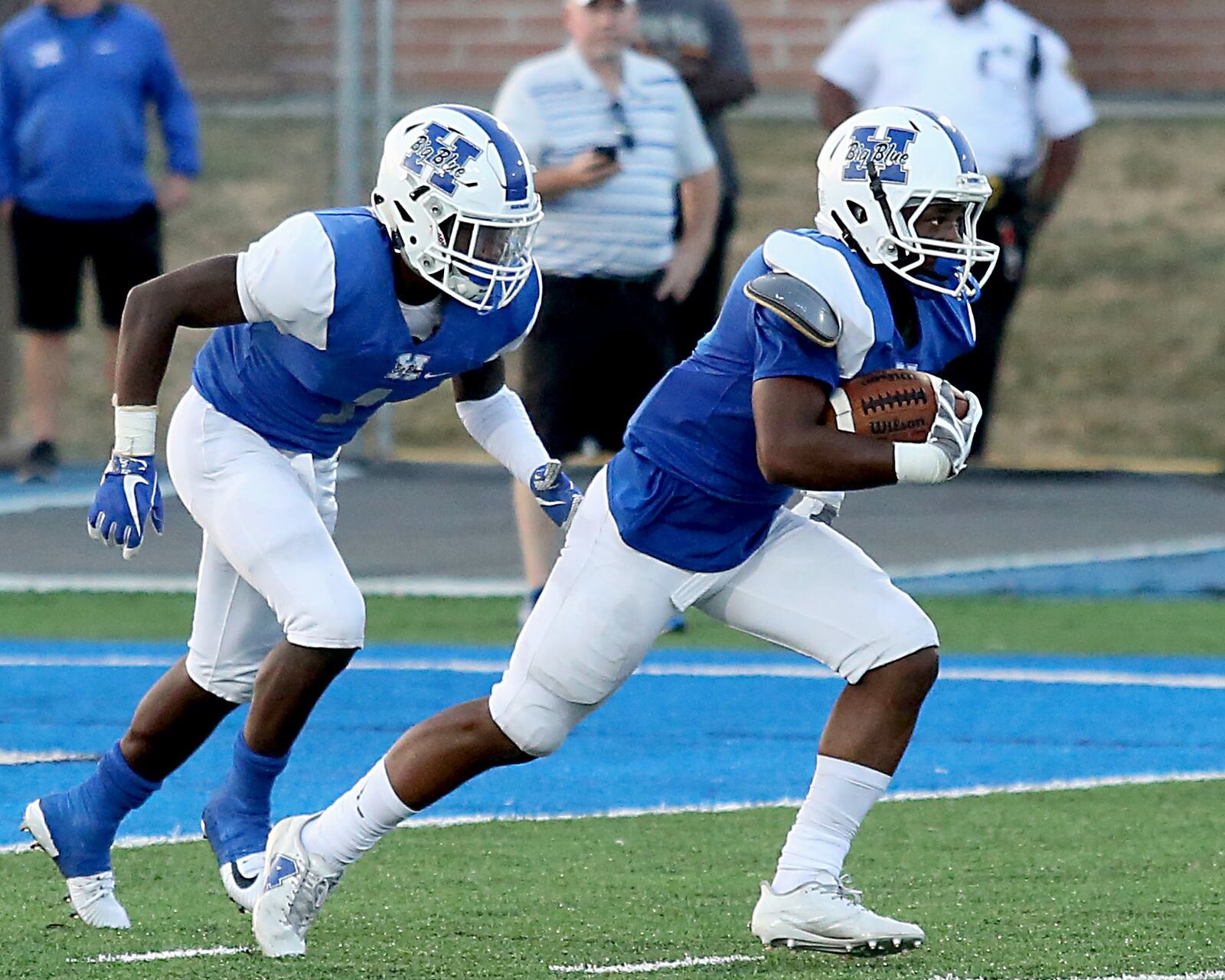 Hamilton’s Deon Tillery returns a Moeller kickoff as Johnny Jones backs him up during their Skyline Chili Crosstown Showdown game at Virgil Schwarm Stadium in Hamilton on Saturday night. CONTRIBUTED PHOTO BY E.L. HUBBARD