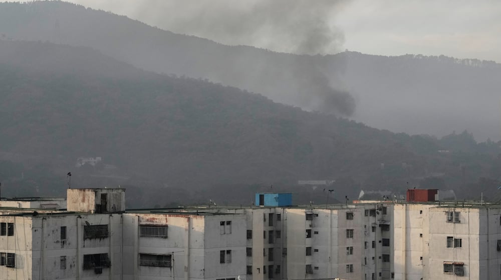 Smoke rises from Fort Tiuna, the main military garrison in Caracas, Venezuela, after multiple explosions were heard and aircraft swept through the area, Saturday, Jan. 3, 2026. (AP Photo/Matias Delacroix)