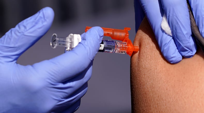 Flu-related hospitalizations in the Dayton area and nationally have surged in part due to a new strain of influenza A that appears to circumvent this season's flu vaccine. Associated Press