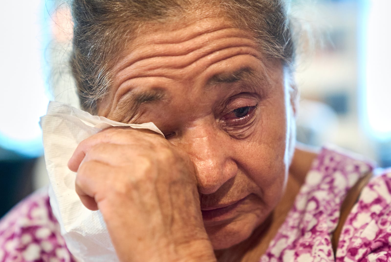 Maria Isabel de Perez, 82, of Welasco, Texas, cries as she recounts how her son was too scared to go to a hospital when he felt intense pain in his abdomen recently, leading to his near-death when his appendix burst, after she attended a diabetes clinic hosted by Holy Family Services, a birth center and women's clinic in the Rio Grande Valley, Wednesday, June 18, 2025, in Weslaco, Texas. (AP Photo/Jacquelyn Martin)