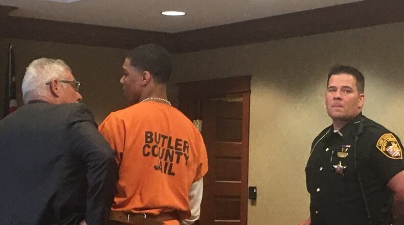 Attorney Jonathan Fox talks to his client, Kameron Tunstall, 19, of Hamilton, who was sentenced to 21 years to life for murder Tuesday by Butler County Common Pleas Judge Charles Pater. RICK McCRABB/STAFF