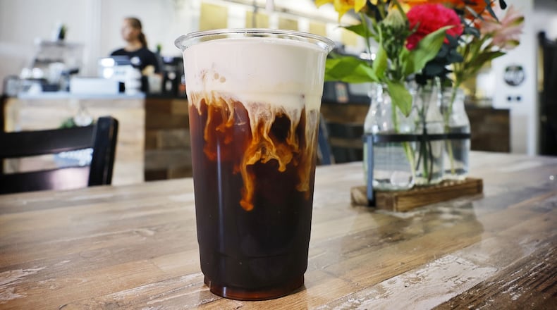 Sweet cream foam is poured over a cold brew coffee at State Street Coffee in Trenton. NICK GRAHAM/STAFF