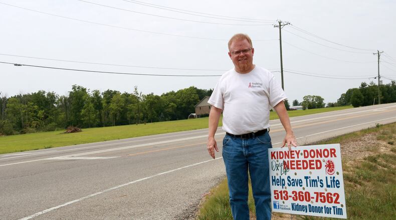 Monroe resident Tim Gentile with one of the signs advertising his search for a kidney donor. EMMA STIEFEL/STAFF