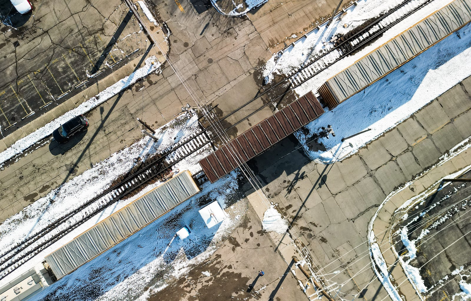 The Butler Street railroad crossing is expected to be closed due to the hotel construction project (out of frame to the lower left) but would also be recommended to be closed to establish a rail quiet zone in the area. Pictured is a CSX train traveling on Wednesday, Dec. 3, 2025, at the four-way intersection of Butler Street and North Fifth Street, and three-way intersection at Butler Street and Witt Way. NICK GRAHAM/STAFF