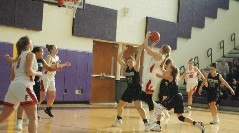 Franklin’s Jordan Rogers gets a shot off over Worthington Kilbourne’s Reilly St. Myer (13) on Sunday afternoon at Reynoldsburg. Franklin won 45-36 in the Gary West Memorial Tipoff Classic VII. RICK CASSANO/STAFF