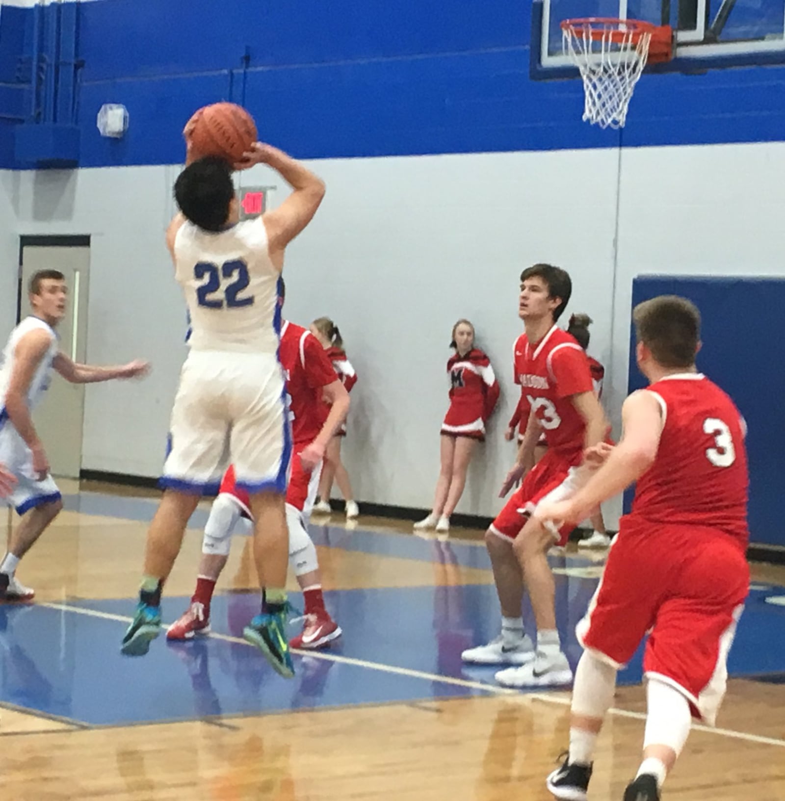 Middletown Christian’s Koen Yee (22) eyes the basket as Madison’s Jake Munafo (23) and Mason Whiteman (3) play defense during Tuesday night’s game at Middletown Christian. RICK CASSANO/STAFF