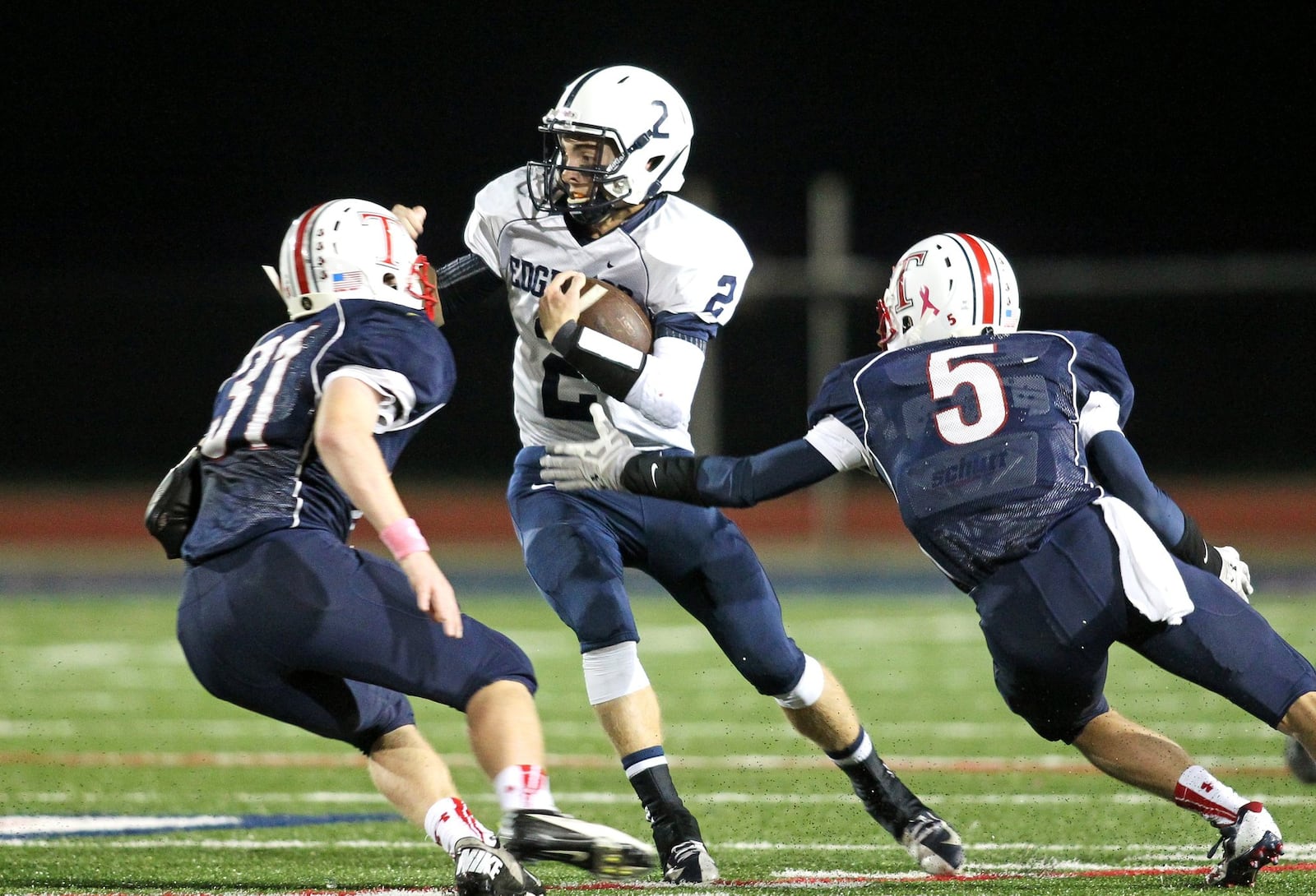 Edgewood quarterback Trace Reynolds (2) looks for running room against the Talawanda defense on Oct. 18, 2013, in Oxford. The host Braves won 28-26. JOURNAL-NEW FILE PHOTO
