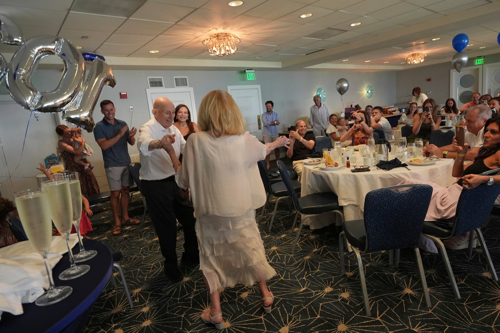 Harold Terens, a World War II veteran who fought in D-Day, dances with his wife Jeanne Swerlin during his 102 birthday party Saturday, July 26, 2025, in Delray Beach, Fla. (AP Photo/Marta Lavandier)