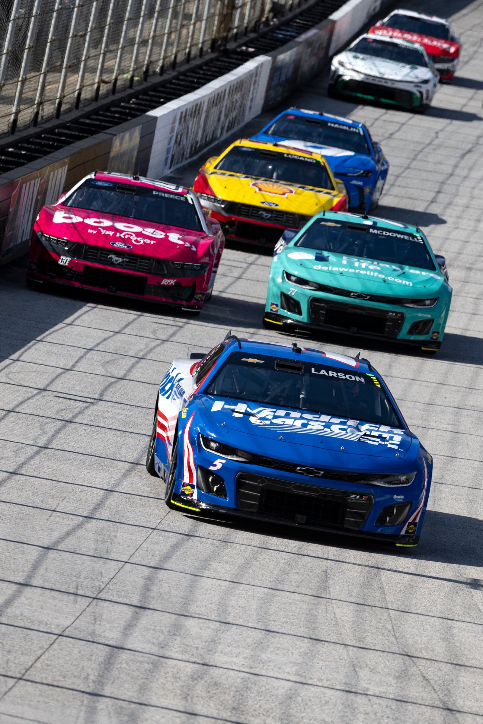 Kyle Larson (5) leads the field into Turn 3 during a NASCAR Cup Series auto race, Sunday, April 13, 2025, in Bristol, Tenn. (AP Photo/Wade Payne)