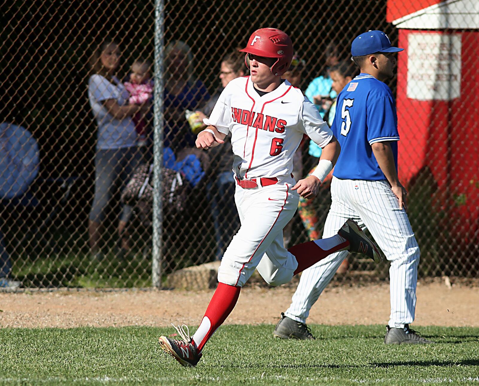 Fairfield’s Andrew Sams heads to home plate as Hamilton pitcher Antonio Perez backs up the cutoff during their game at Joe Nuxhall Field in Fairfield on May 7. The Indians won 4-3. CONTRIBUTED PHOTO BY E.L. HUBBARD