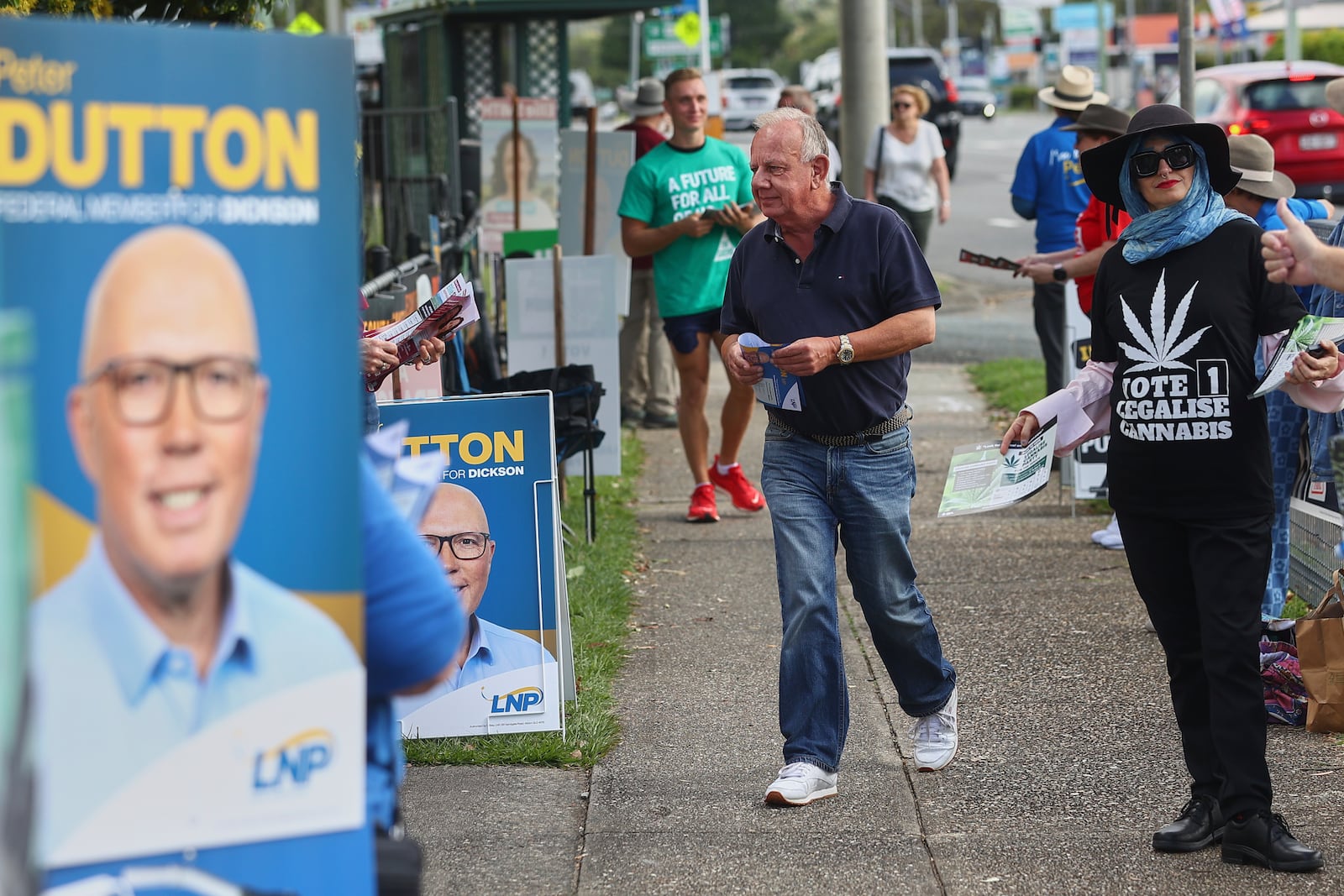 A man walks into a polling station in Brisbane, Australia, Saturday, May 3, 2025. (AP Photo/Pat Hoelscher)