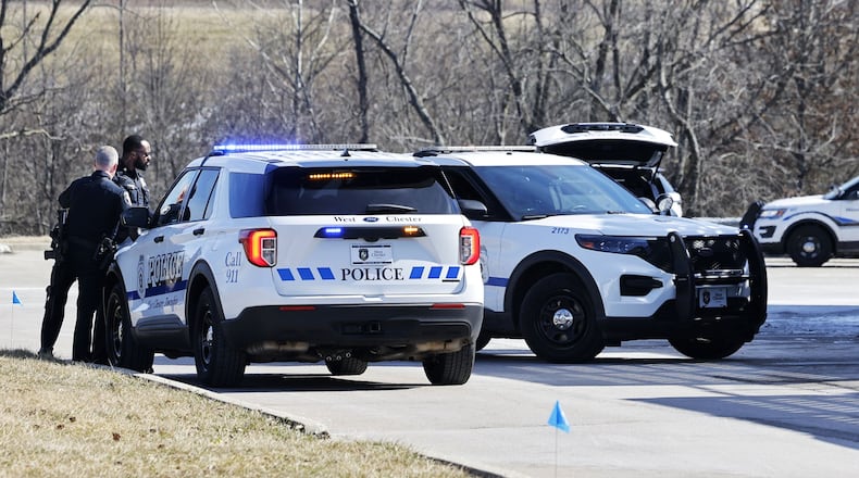 Police investigating at Walmart in West Chester Twp. Monday after a report of a male with a gun walking behind the building. NICK GRAHAM/STAFF