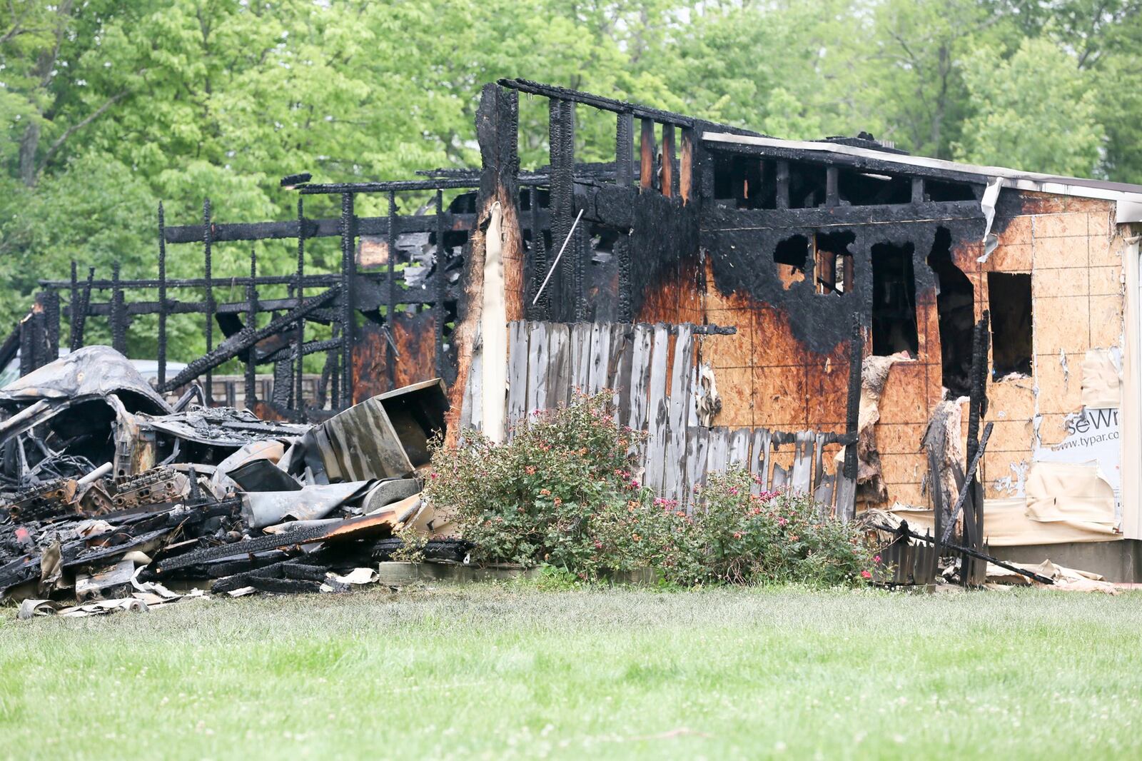 Crews from Wayne and Madison townships battled a fully engulfed structure fire behind a house on Oxford-Middletown Road on Monday, June 5. GREG LYNCH / STAFF