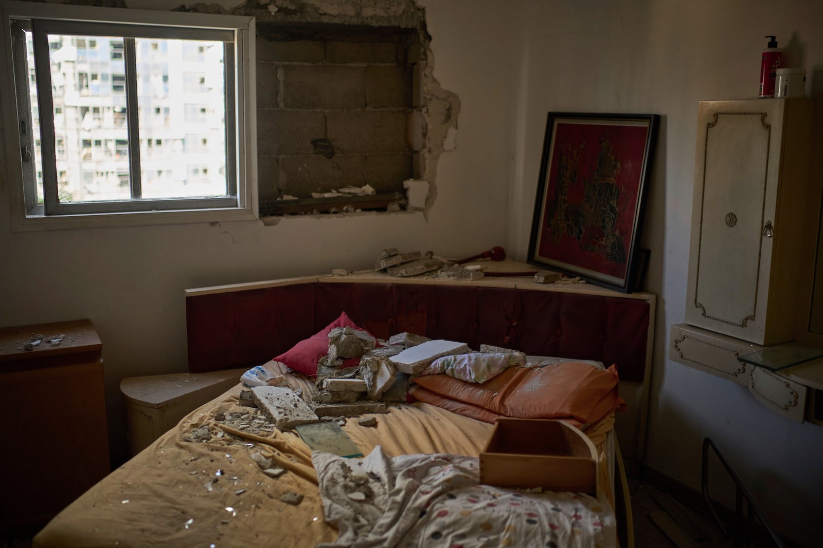 Debris are seen over a bed inside a damaged apartment a day after of an Iranian missile strike in Ramat Gan, Israel, Friday, June 20, 2025. (AP Photo/Leo Correa)