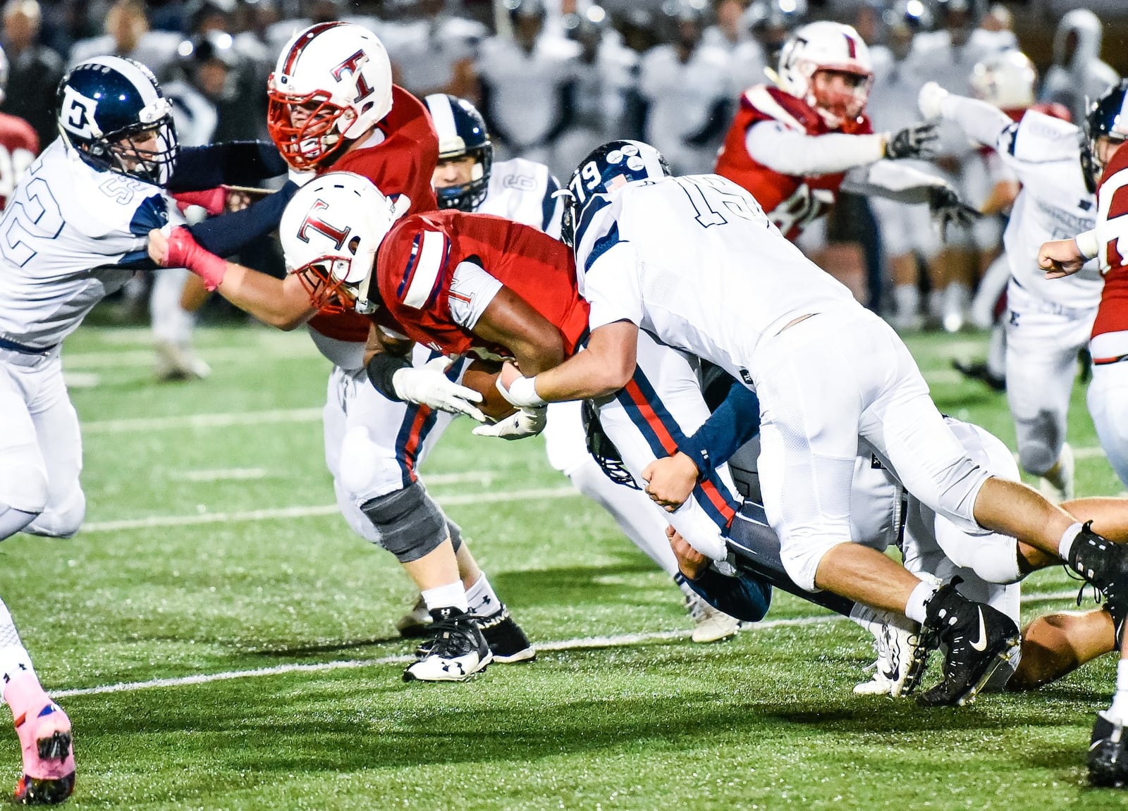 Edgewood’s Clayton Gerber tackles Talawanda’s Terell Wills during their game Friday night in Oxford. NICK GRAHAM/STAFF