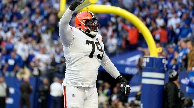 Cleveland Browns offensive tackle Dawand Jones (79) celebrates after a touchdown by teammate Kareem Hunt during the second half of an NFL football game against the Indianapolis Colts, Sunday, Oct. 22, 2023, in Indianapolis. The Browns won 39-38. (AP Photo/Michael Conroy)