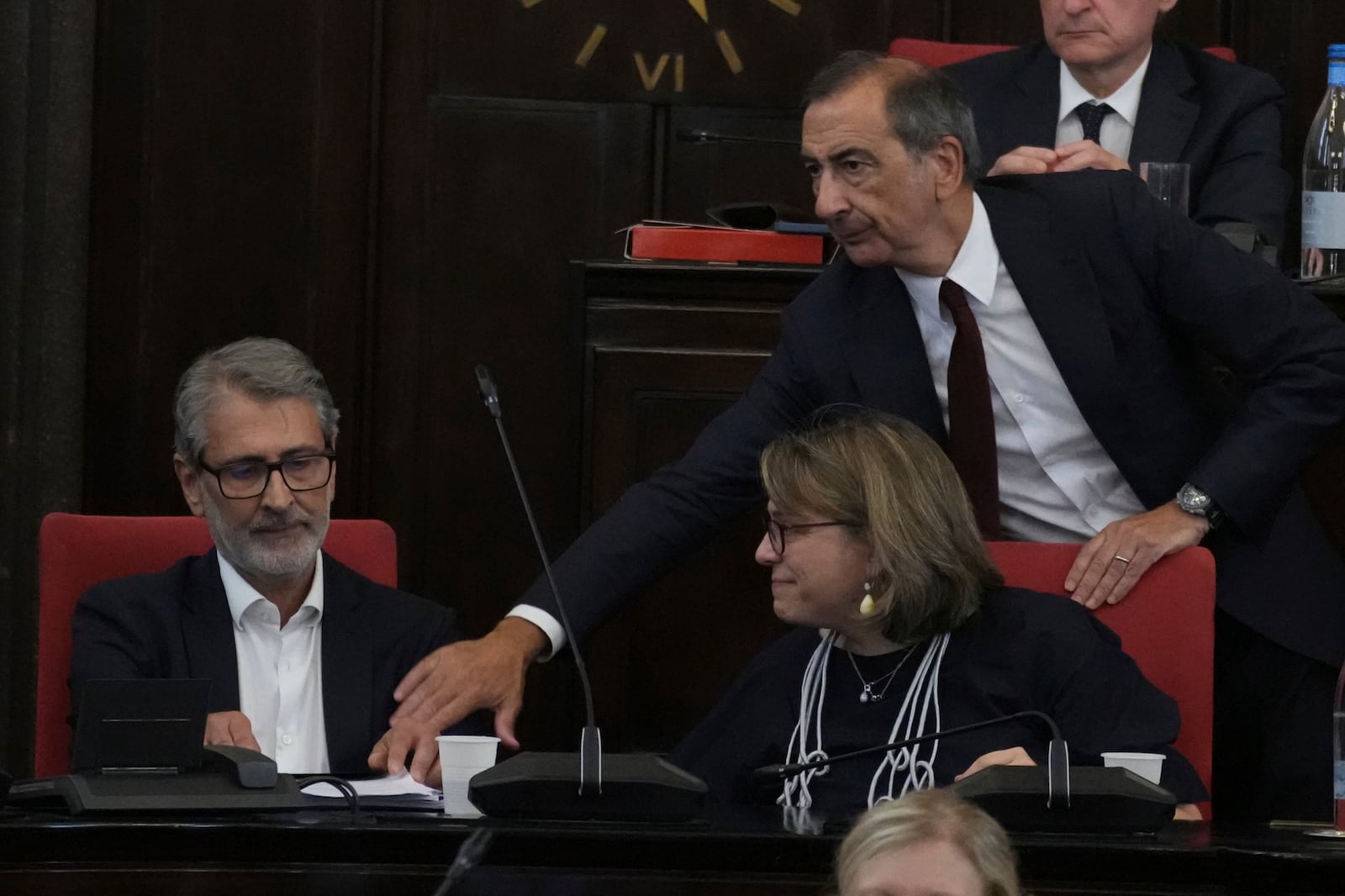 Milan's Mayor Giuseppe Sala, right, congratulates the Councillor for Urban Regeneration, Giancarlo Tancredi, left, after his speech in the City Council Monday, July 21, 2025, in Milan, northern Italy, as prosecutors are investigating more than 70 individuals, including Mayor Sala and Tancredi, over a sprawling corruption probe into the city's real estate industry. (AP Photo/Antonio Calanni)