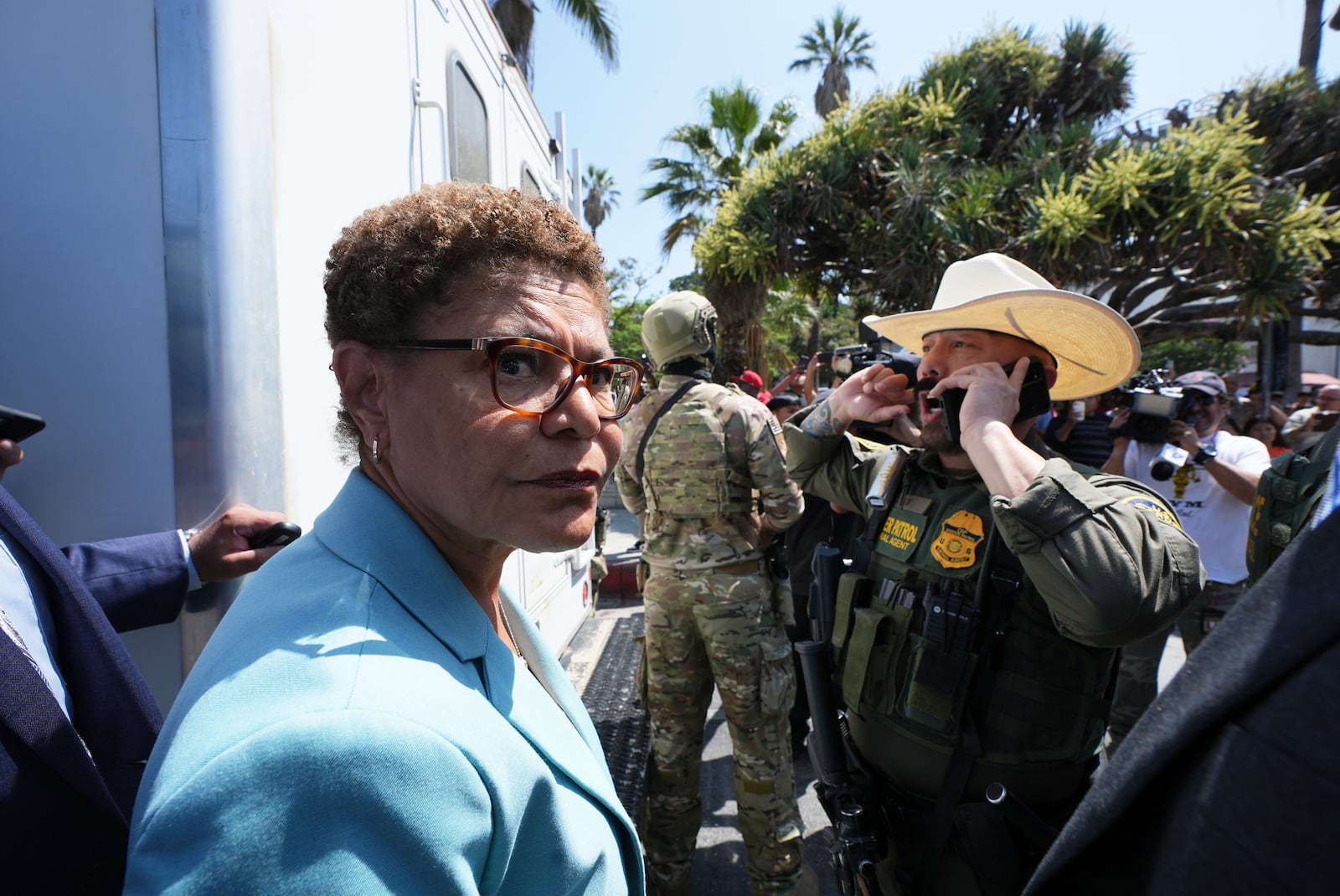 Los Angeles Mayor Karen Bass stands in front of a border patrol federal agent at MacArthur Park Monday, July 7, 2025, in Los Angeles. (AP Photo/Damian Dovarganes)