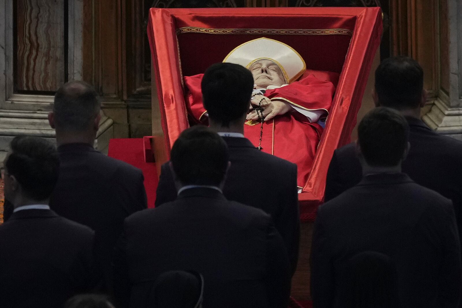 Vatican personnel pay their respects to Pope Francis inside St. Peter's Basilica at the Vatican, Wednesday, April 23, 2025, where his body will lie in state for three days. (AP Photo/Andrew Medichini, Pool)