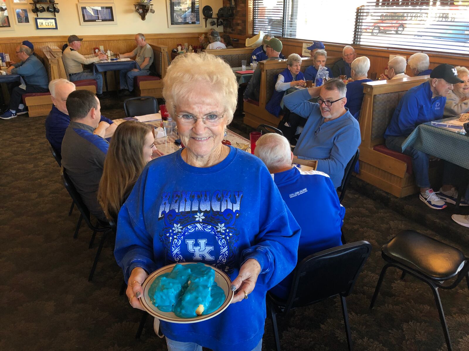 Hilda Ratliff, the longtime owner of Mom's Restaurant in Franklin, shows off her blue gravy that she makes every year to celebrate the University of Kentucky men's basketball team playing in the NCAA Tournament. A large crowd of UK fans gathered at Mom's Wednesday morning. RICK McCRABB/STAFF