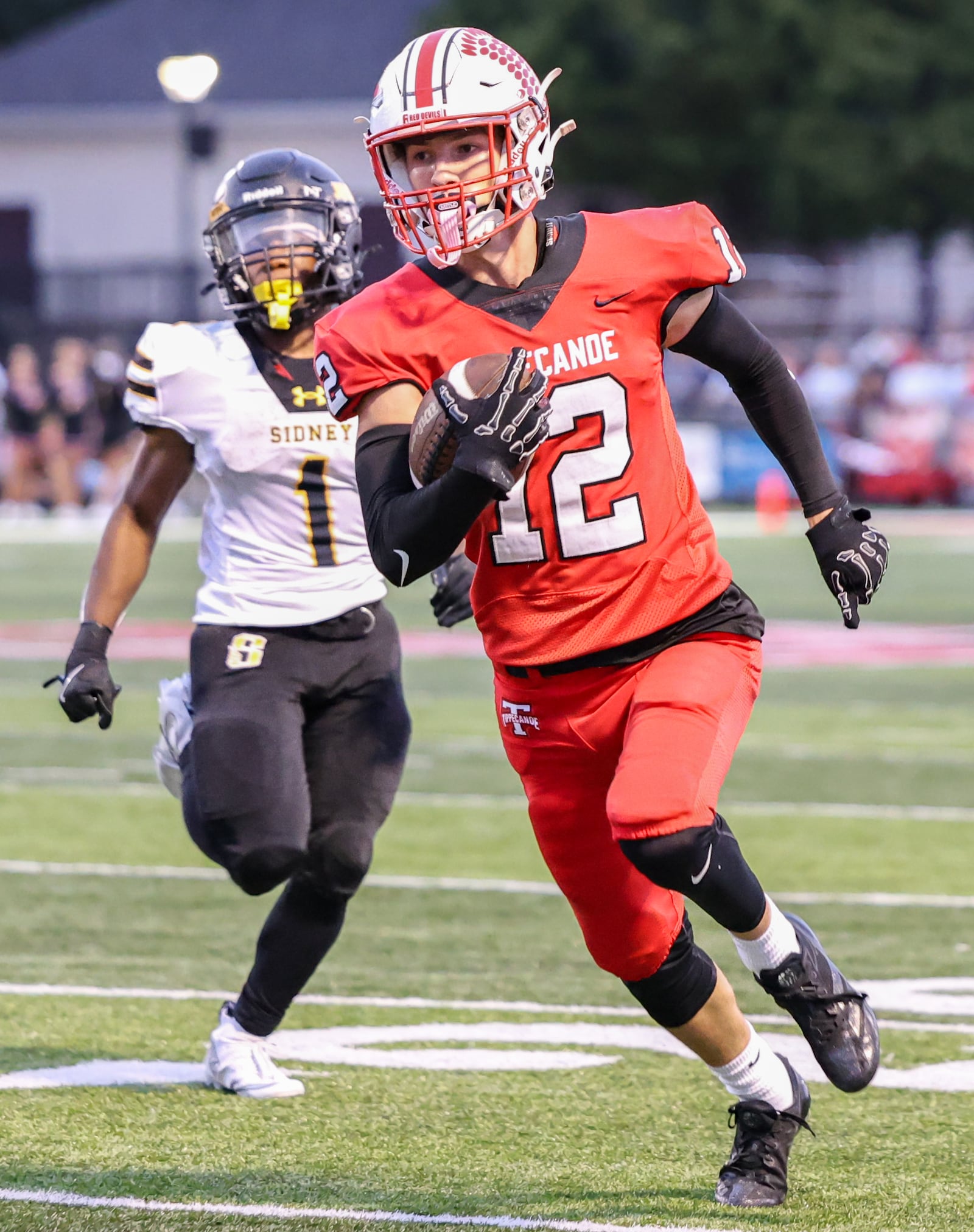 Tippecanoe senior receiver Max Deckard runs as Sidney's Jamari Combs trails during a Miami Valley League game on Thursday, Sept. 25 at Tipp City Park. BRYANT BILLING / STAFF