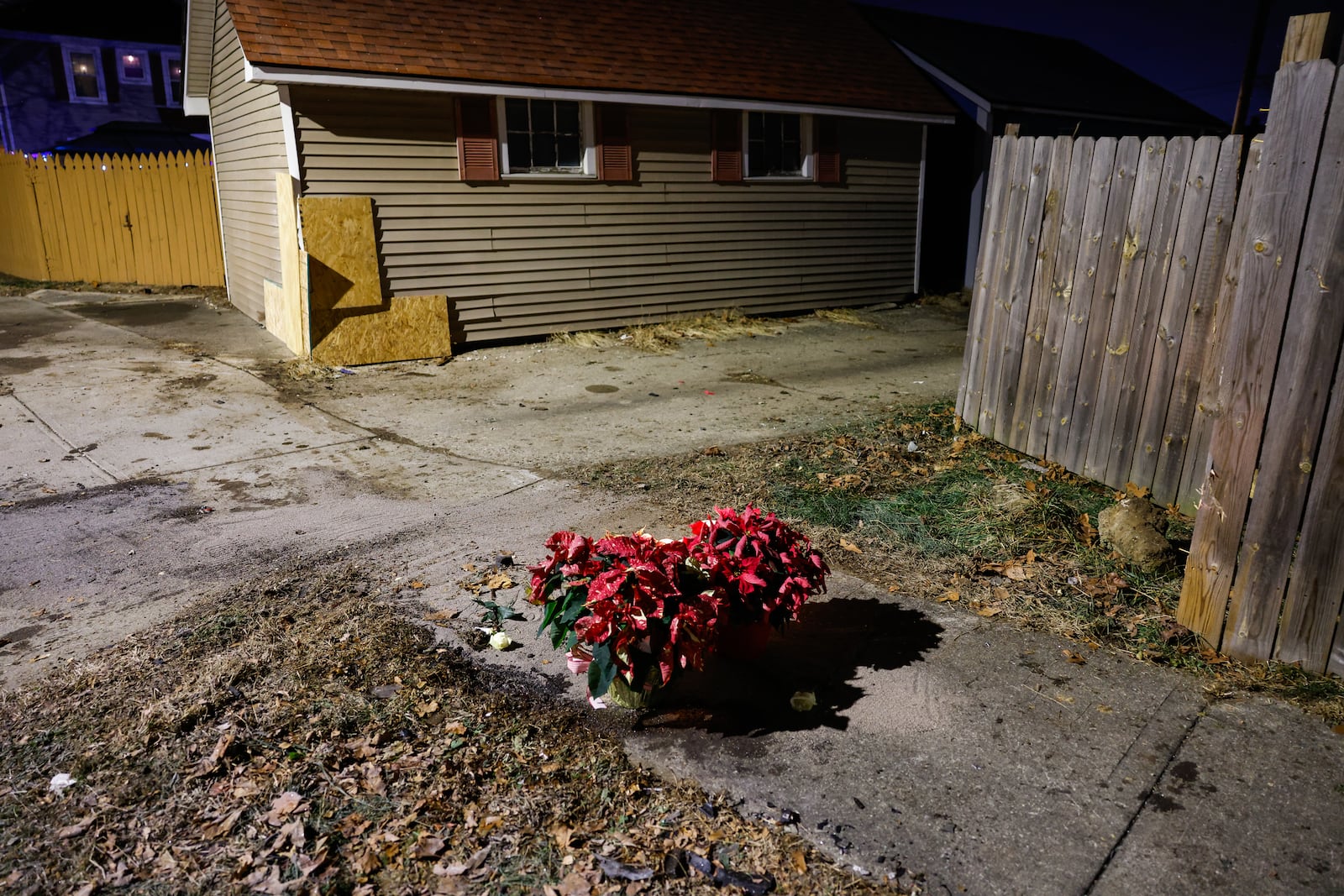 Flowers and candles were left near the intersection of River Road and Hooven Avenue on Sunday, Dec. 21, 2025. The area was the site of a crash that killed three people earlier in the day. NICK GRAHAM / STAFF
