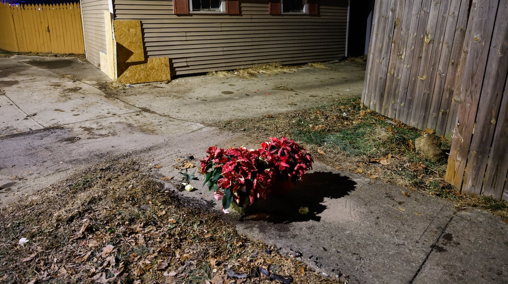 Flowers and candles were left near the intersection of River Road and Hooven Avenue on Sunday, Dec. 21, 2025. The area was the site of a crash that killed three people earlier in the day. NICK GRAHAM / STAFF