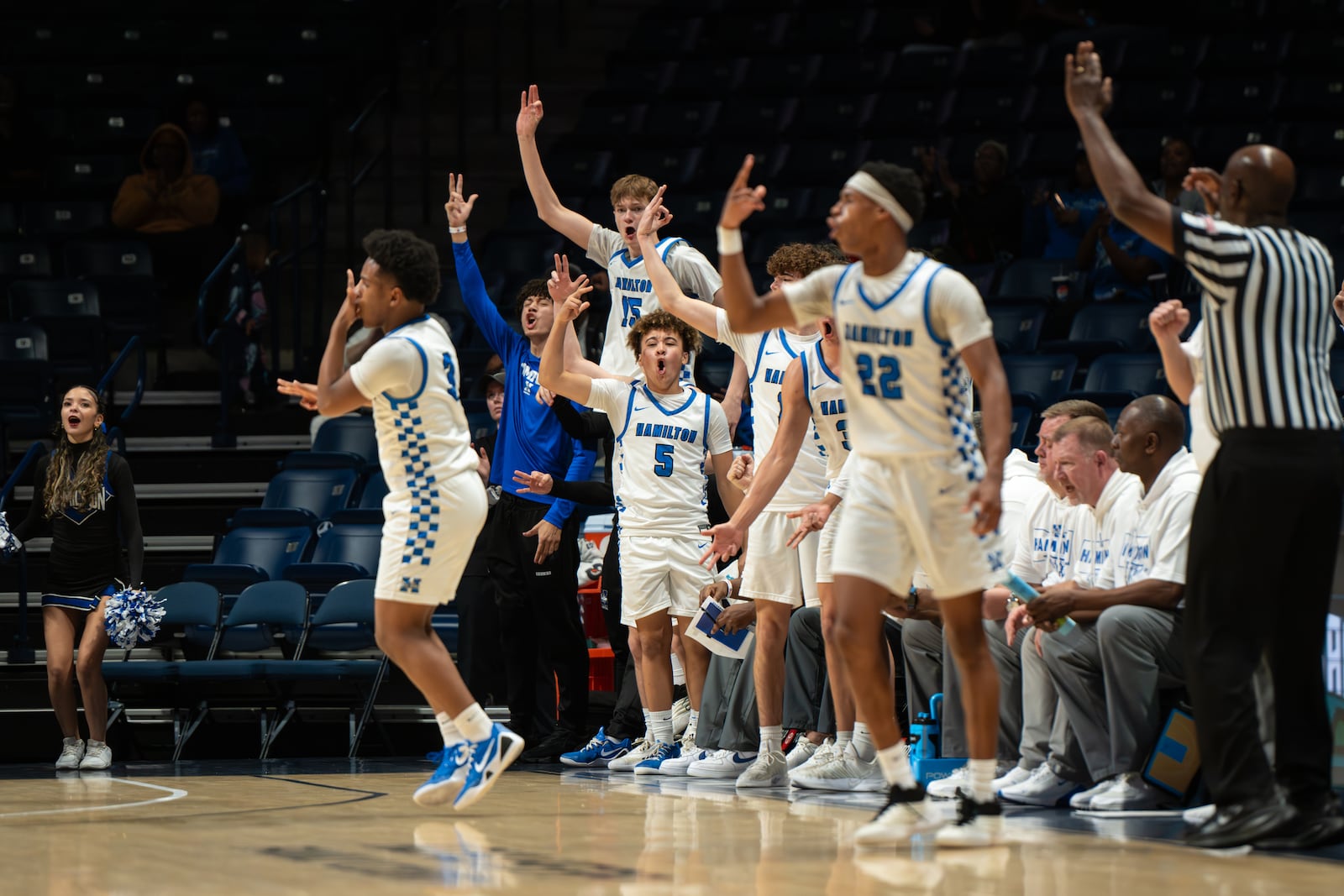 The Hamilton boys basketball team celebrates during their Division I district final game against Princeton Saturday at Cintas Center. AJ FULLAM / CONTRIBUTED