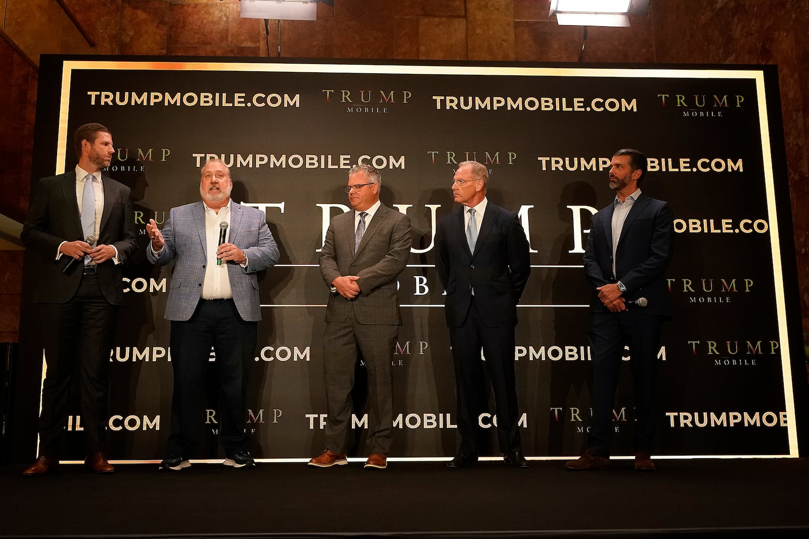 Eric Trump, Don Hendrickson, Eric Thomas, Patrick O'Brien and Donald Trump Jr., left to right, participate in the announcement of Trump Mobile, in New York's Trump Tower, Monday, June 16, 2025. (AP Photo/Richard Drew)