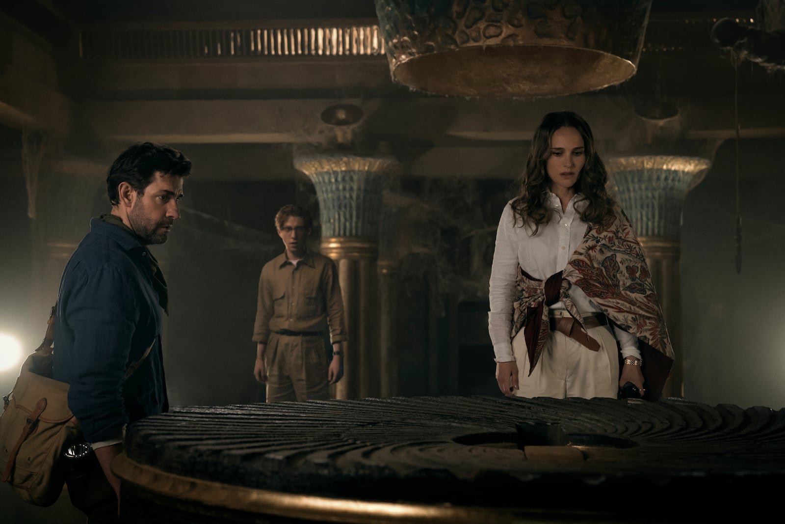 This image released by Apple TV+ shows John Krasinski, from left, Domhnall Gleeson, and Natalie Portman in "Fountain of Youth." (Christopher RaphaelApple TV+ via AP)