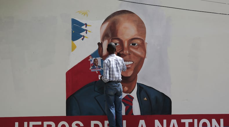 FILE - Artists paint a portrait of slain Haitian President Jovenel Moise near the presidencial residence where he was assassinated two years ago in the Petion-ville area of Port-au-Prince, Haiti, July 7, 2023. (AP Photo/Odelyn Joseph, File)