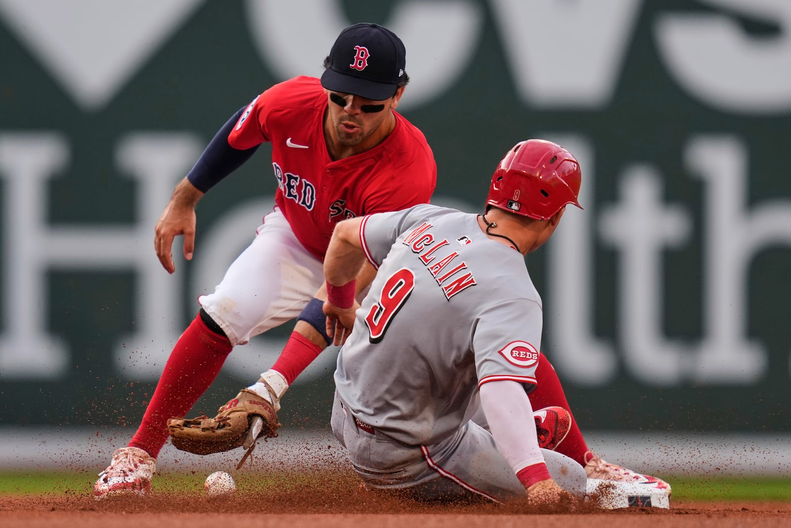 Boston Red Sox second baseman Marcelo Mayer, left, loses control of the ball as Cincinnati Reds' Matt McLain safely steals second during the first inning of a baseball game at Fenway Park, Wednesday, July 2, 2025, in Boston. (AP Photo/Charles Krupa)
